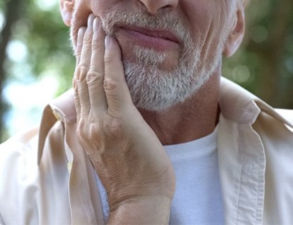 Man holding his aching jaw