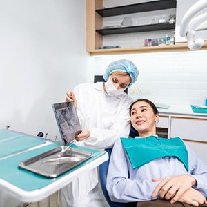 Dentist and patient reviewing X-ray together