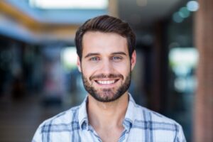 Man smiling after finishing his smile makeover plan